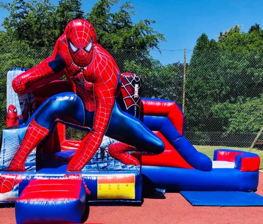 Superhero-themed bounce house with slide